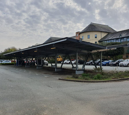 Daytime view from the parking lot of a new solar carport in Pembrokeshire County, Wales.