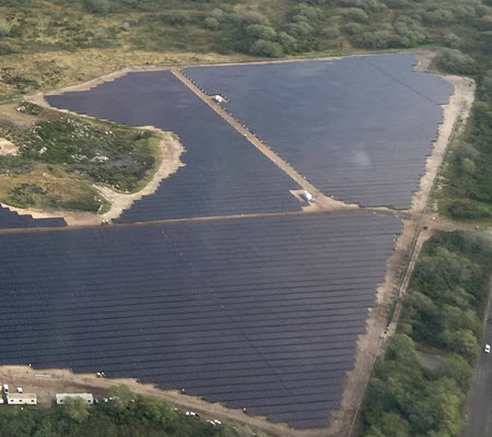 Daytime aerial view of a solar farm in Kupono Hawaii