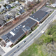 Daytime aerial view of the Wakefield Massachusetts Municipal Gas and Light Department building showing a rooftop solar power system