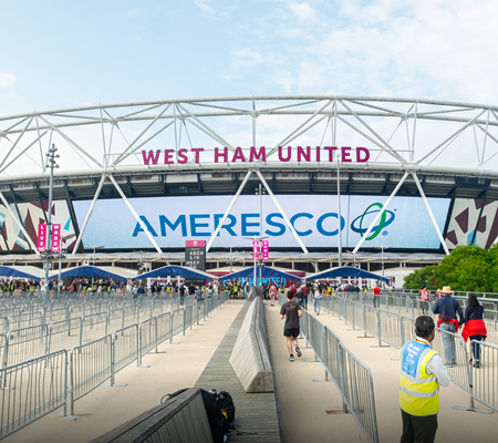 Daytime view of London Stadium featuring an Ameresco banner over the entrance